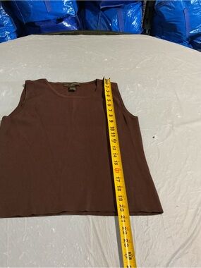 Linda Mathew’s.  
Brown Crewneck Sleeveless Tank Top.